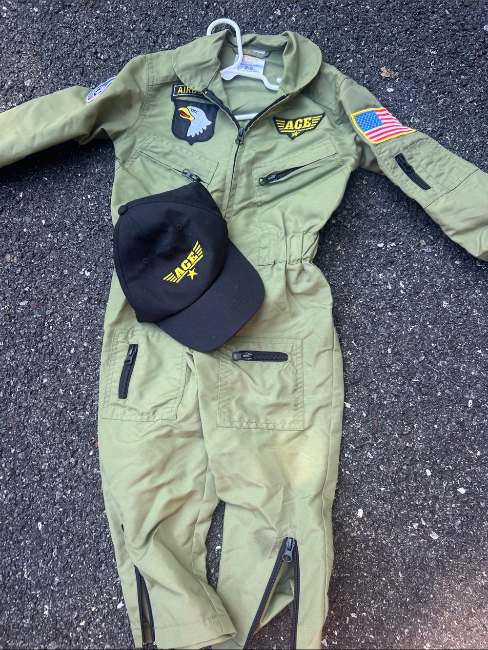 Get real gear dress up for kids.  Green Pilot One-Piece Jumpsuit with Black Cap